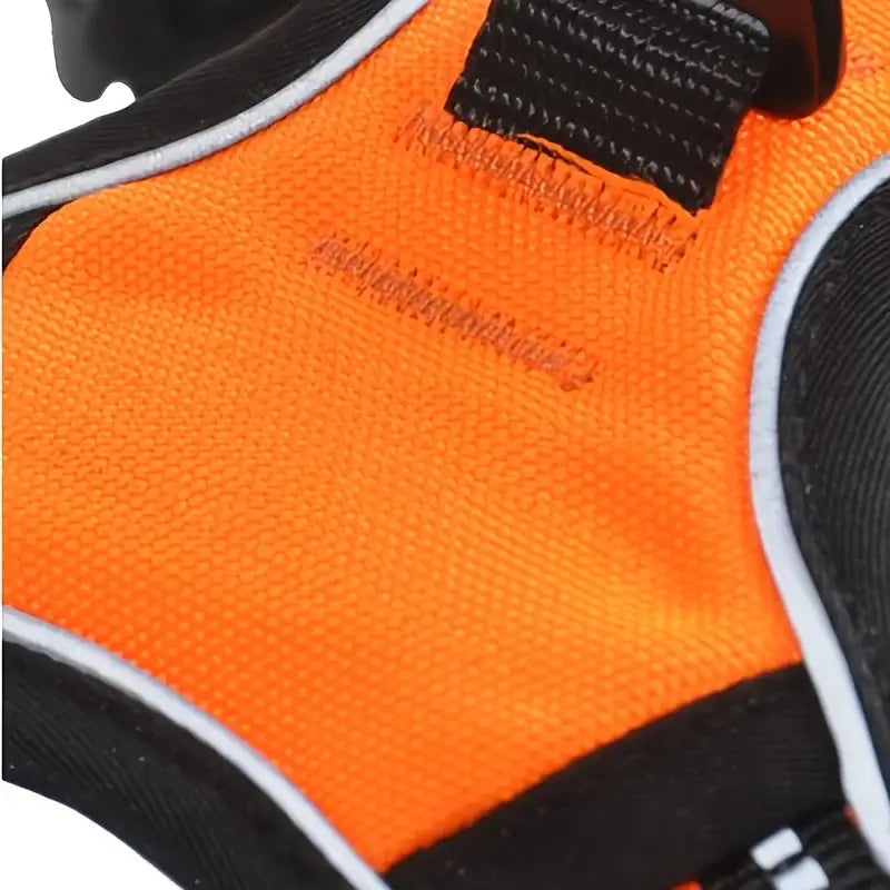 Bright orange and black sports glove or cycling glove with mesh fabric and stitching details.