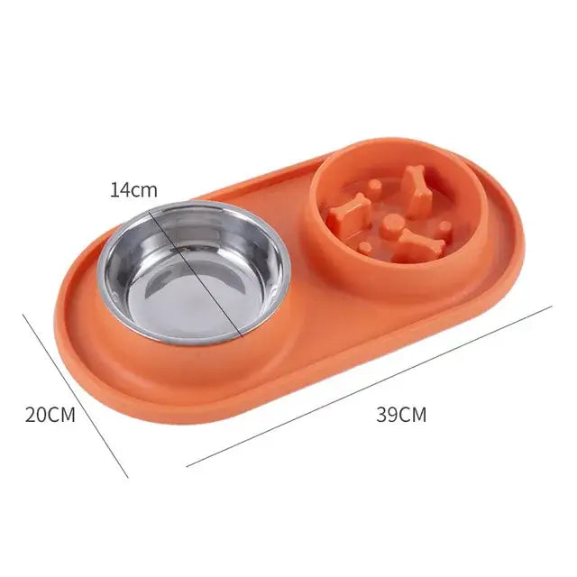 Pet feeding bowl set with a stainless steel dish and a slow-feed compartment on an orange base.