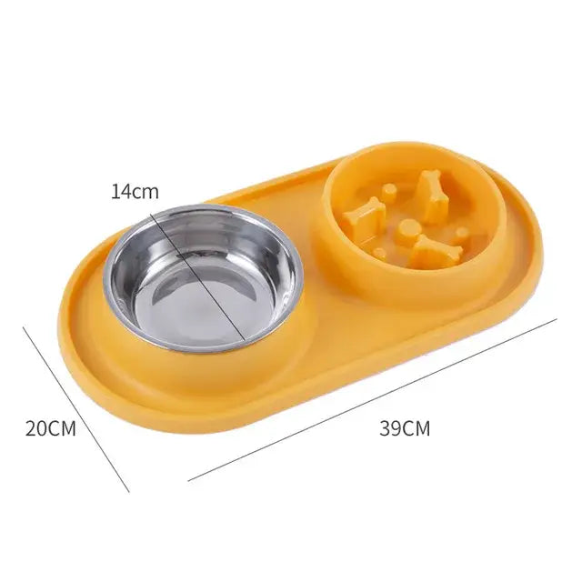 Yellow plastic pet feeding station with a stainless steel bowl and a slow-feed compartment.