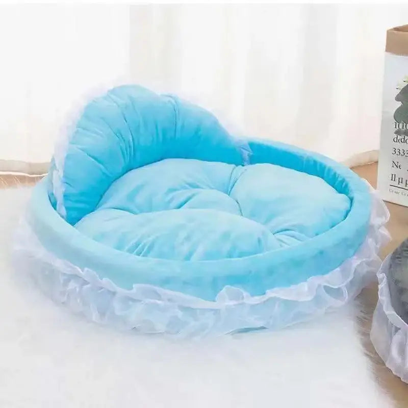 Plush, light blue pet bed with white ruffled trim.