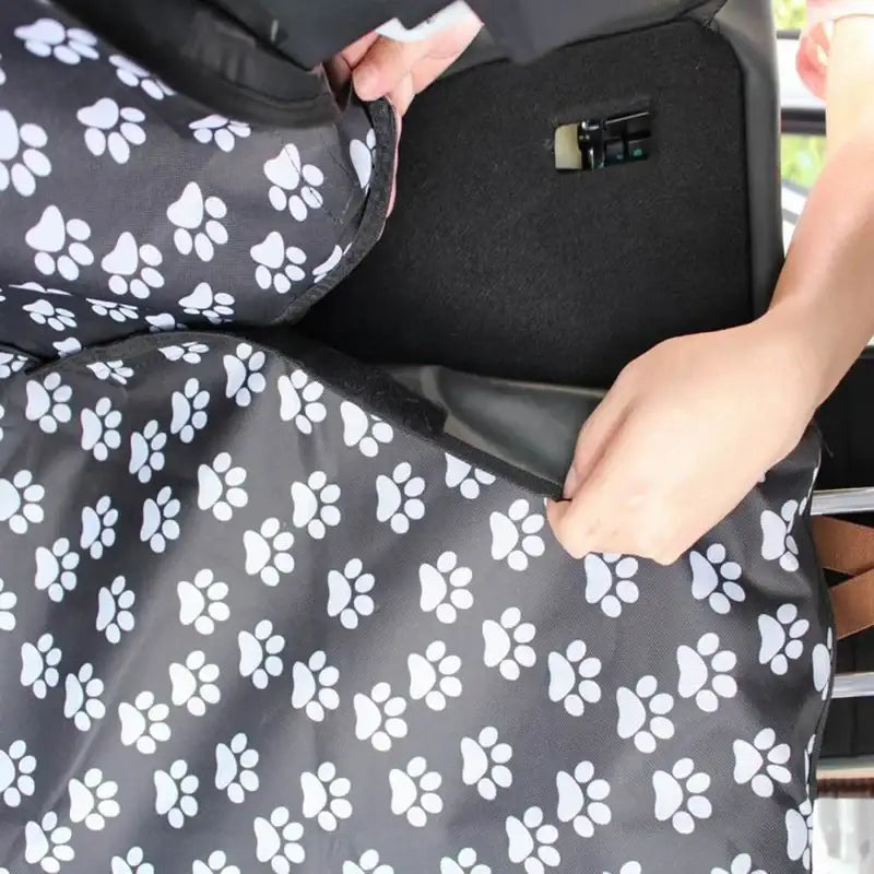 Car seat cover with a paw print pattern.