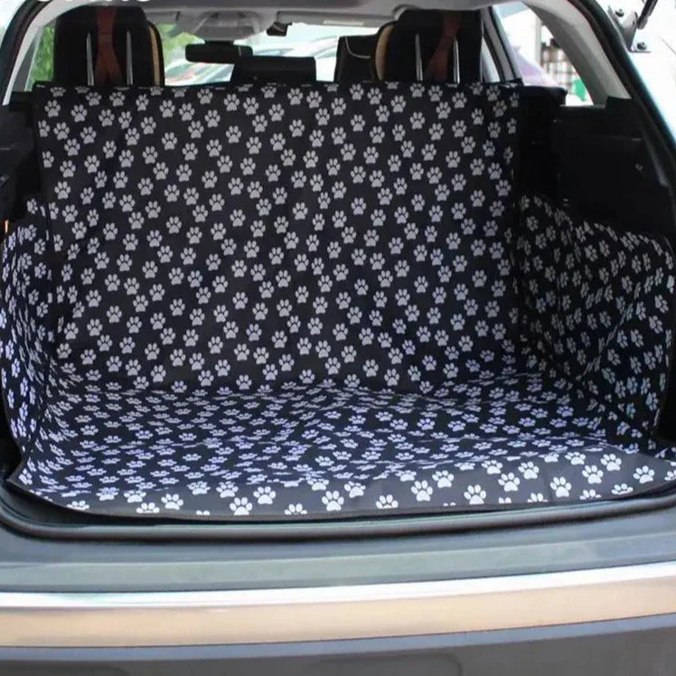 Paw print patterned car trunk liner covering the cargo area of a vehicle.