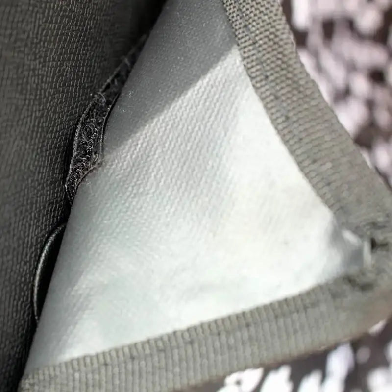 Triangular piece of fabric or material with a visible seam or edge.