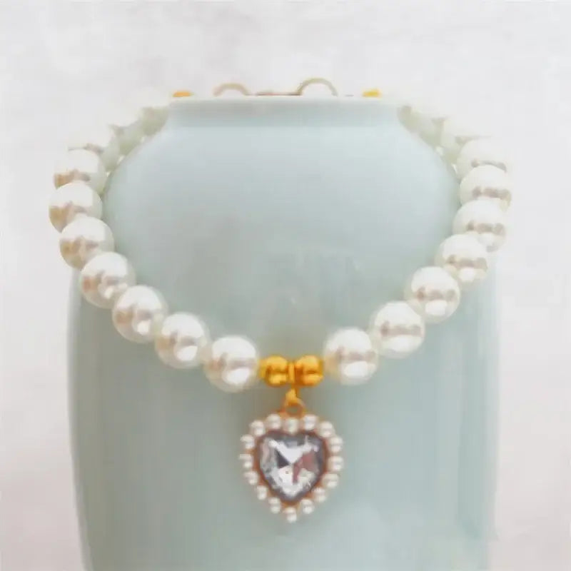 Pearl necklace with a heart-shaped crystal pendant.