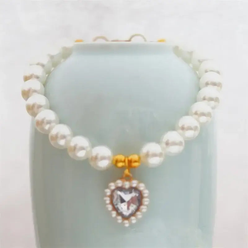 Pearl necklace with a heart-shaped crystal pendant.