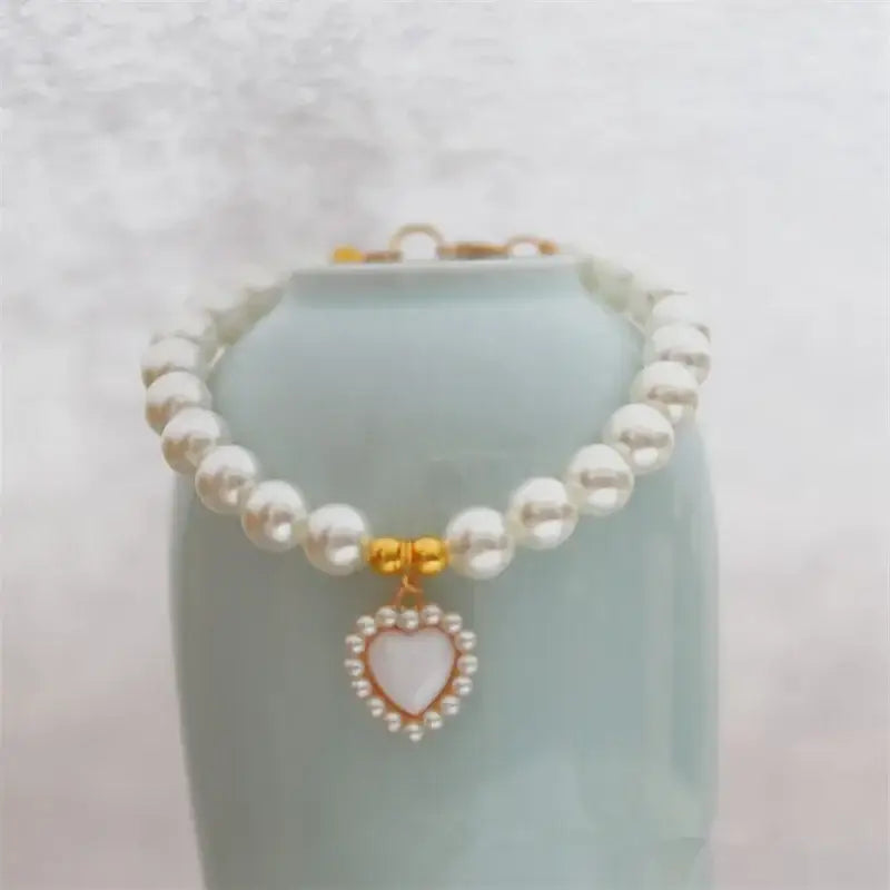 Pearl necklace with a heart-shaped pendant.