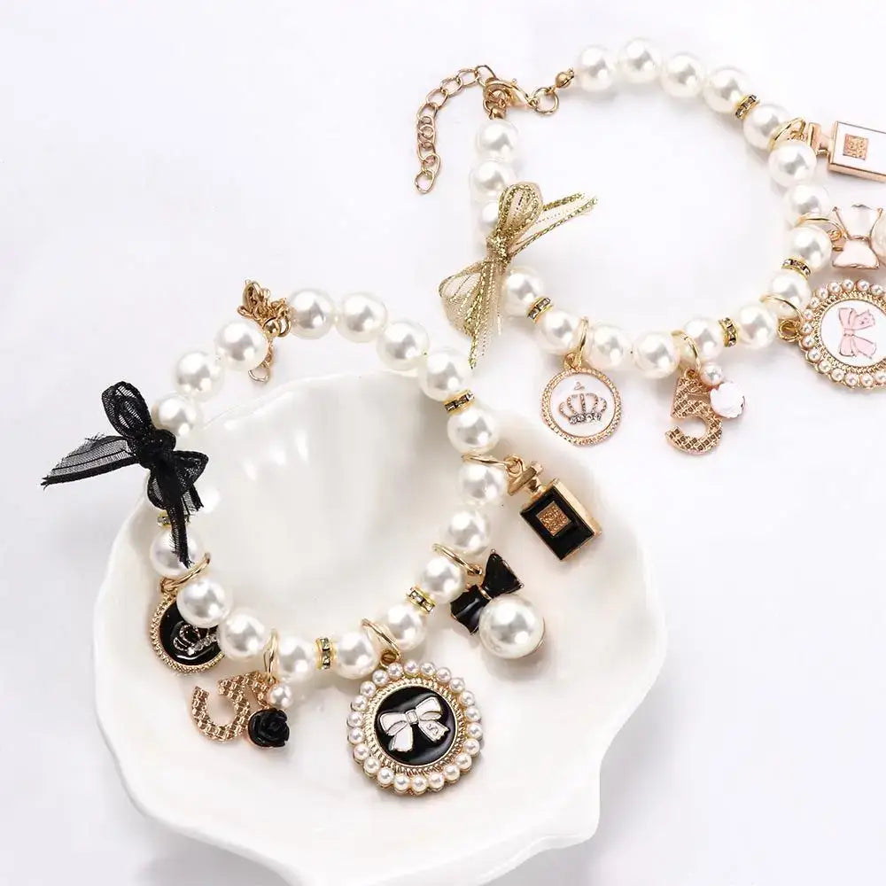 Pearl charm bracelets with various decorative pendants.