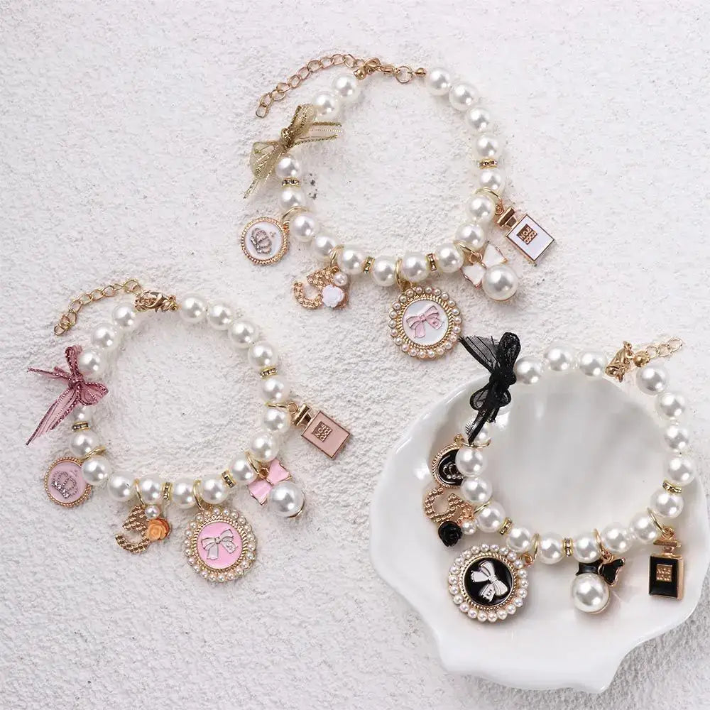 Pearl charm bracelets with various decorative pendants and charms.