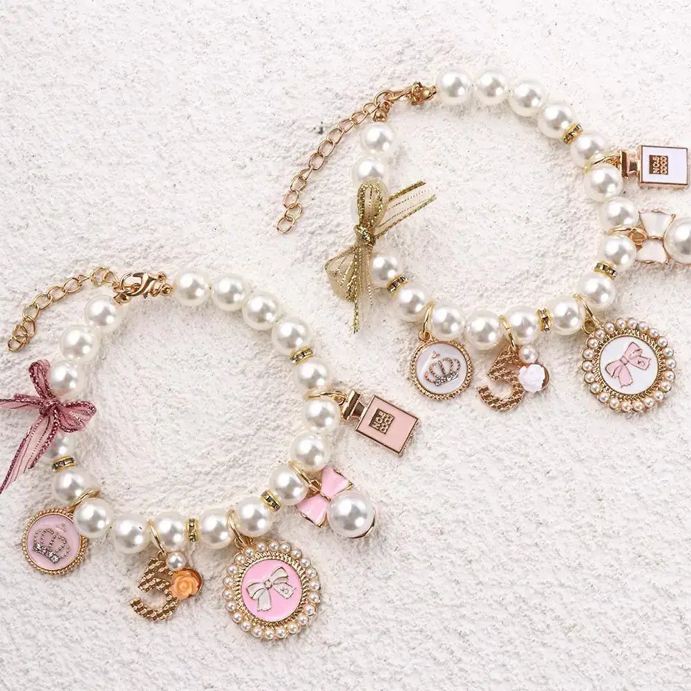 Pearl charm bracelets with various decorative pendants and bows.