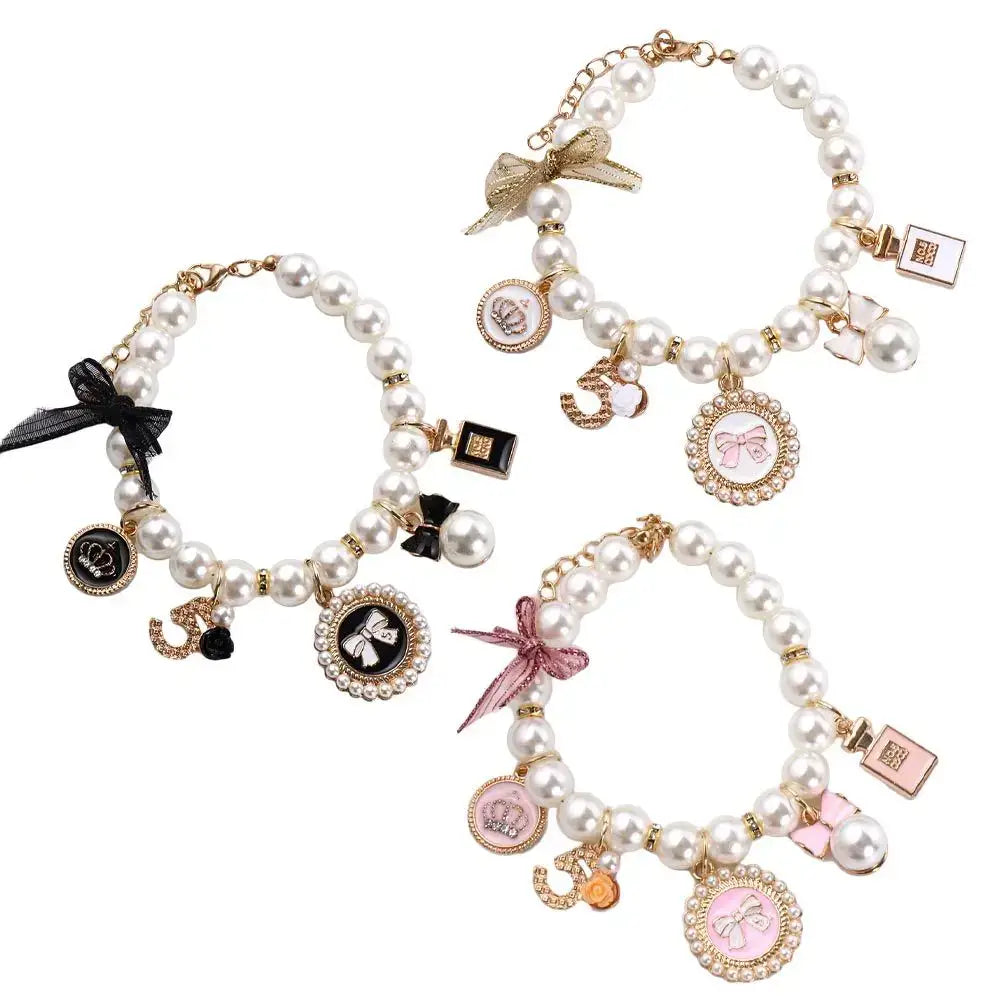 Pearl charm bracelets with various decorative pendants and bows.