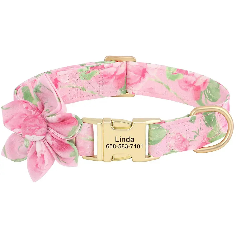 Pink floral dog collar with a gold buckle and personalized name tag.