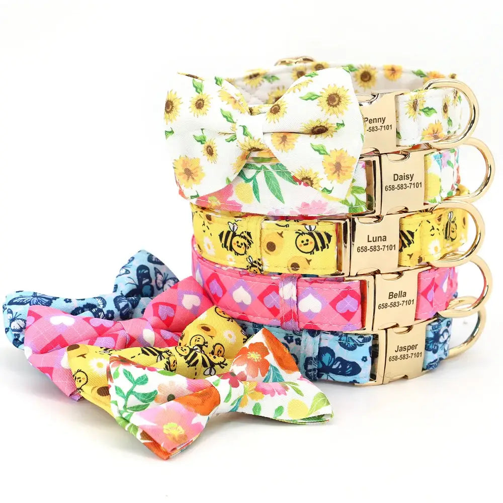 Colorful stack of personalized dog collars with matching patterned fabric bows.