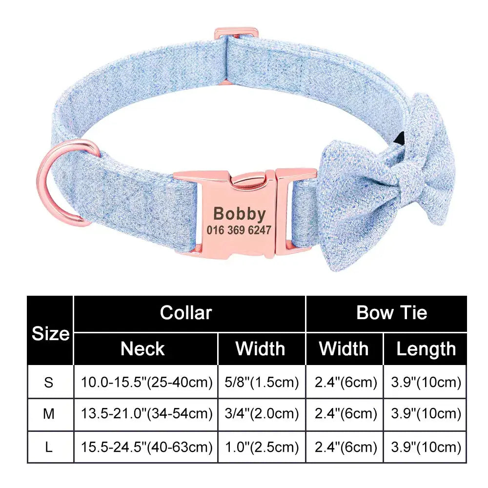 Light blue fabric dog collar with a pink buckle and bow accessory, featuring a personalized name tag.