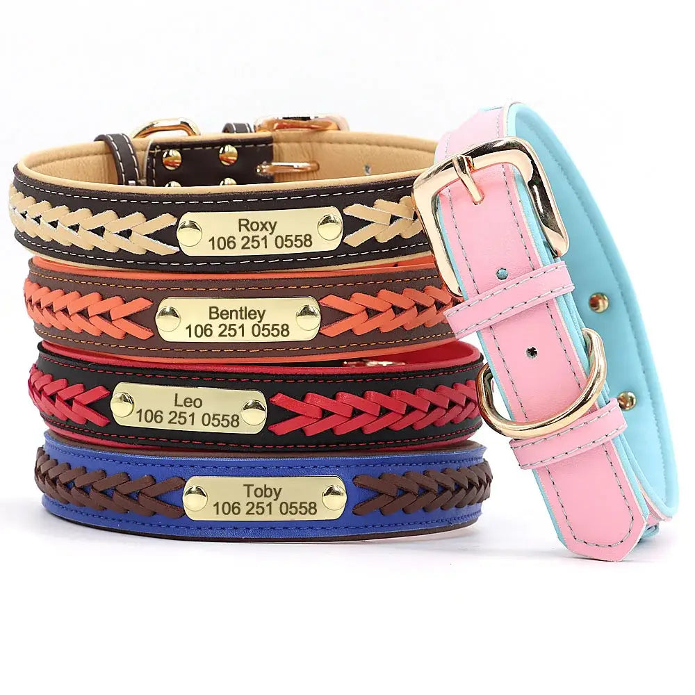 Stack of personalized leather dog collars with engraved name tags and phone numbers.