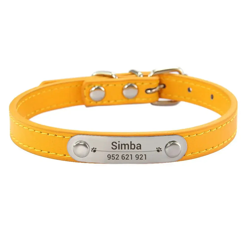 Yellow leather dog collar with a metal nameplate and studs.