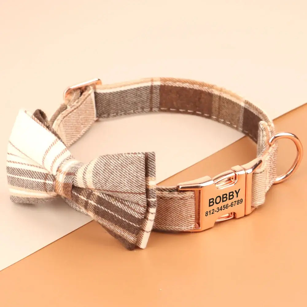 Plaid dog collar with a bow tie and personalized metal tag.