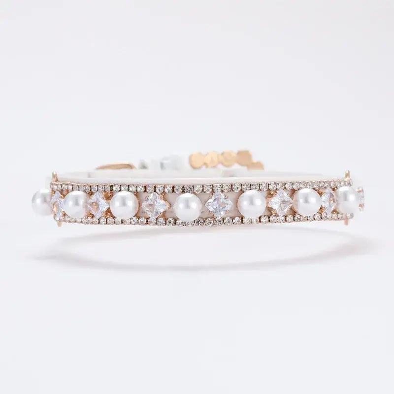 Elegant pearl and diamond bracelet with a delicate gold setting.