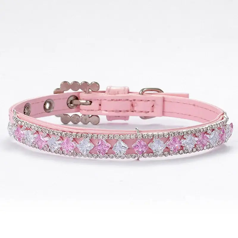 Pink leather dog collar adorned with rhinestones and flower-shaped crystals.