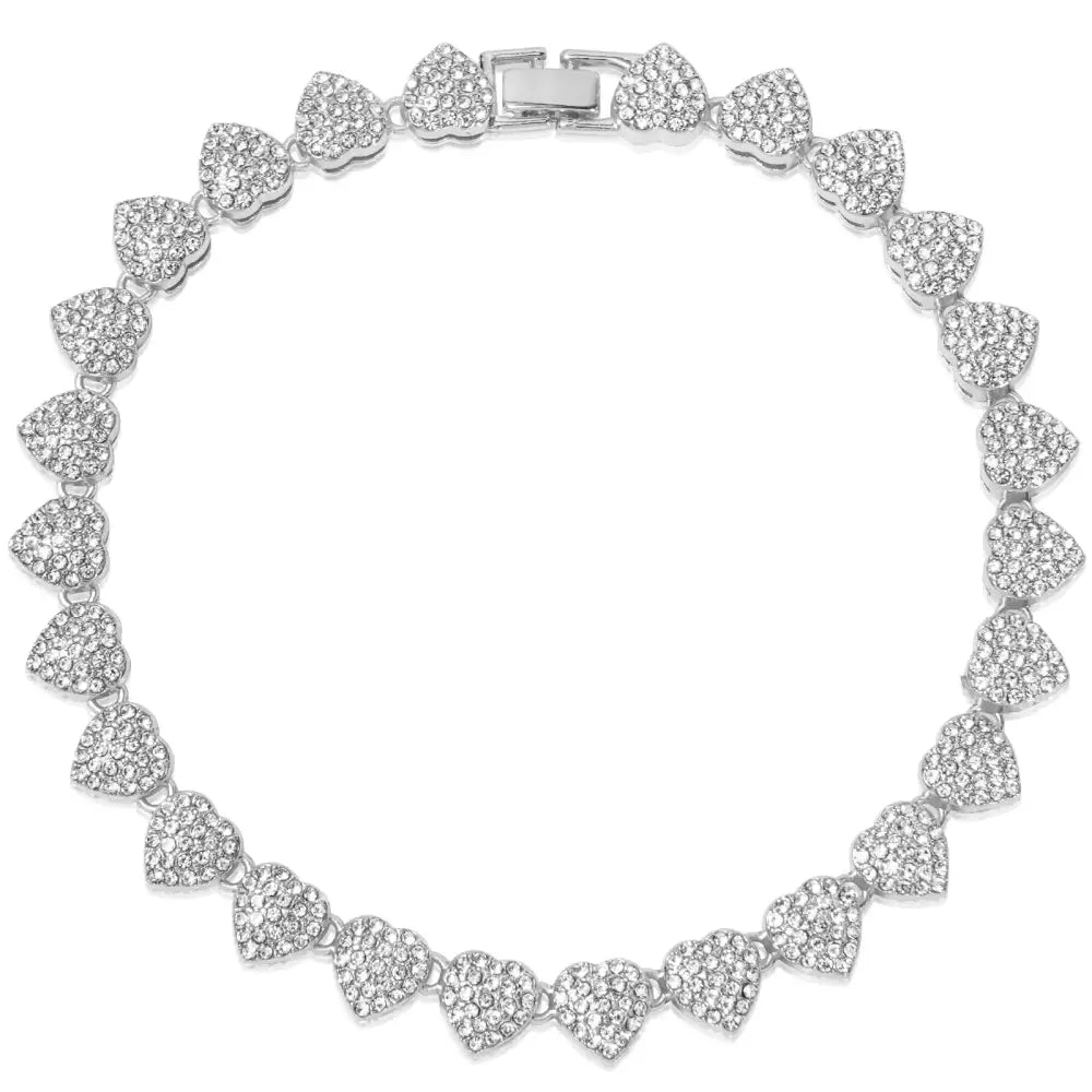 Sparkling silver bracelet composed of heart-shaped links encrusted with diamonds or crystals.