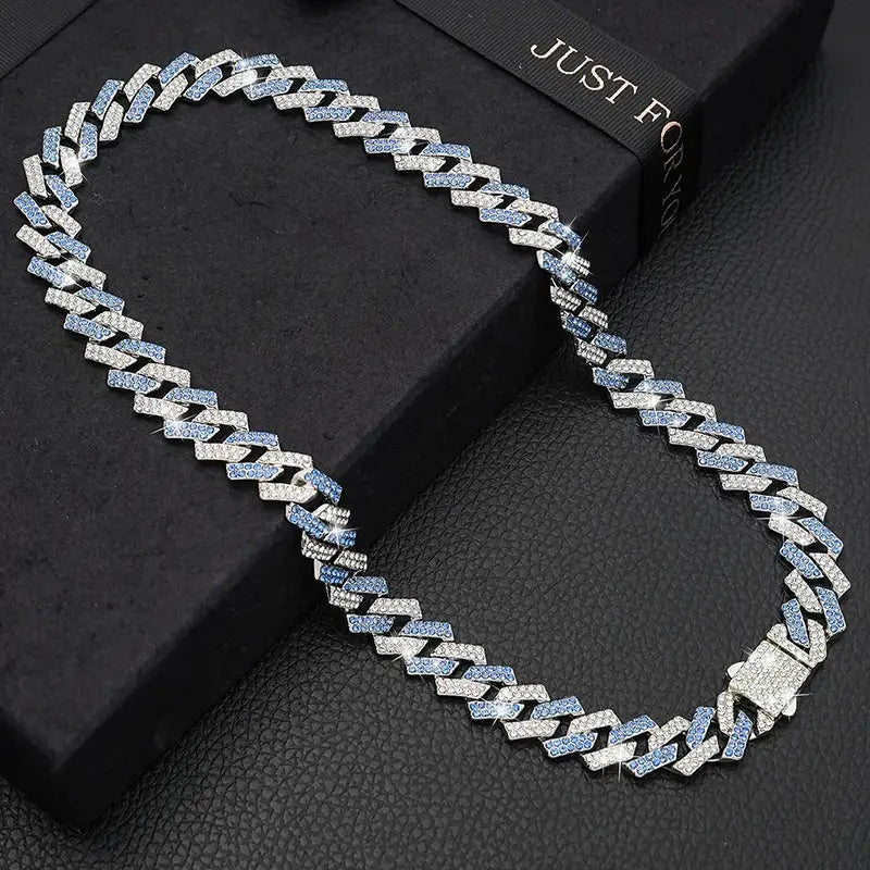 Diamond-encrusted Cuban link chain necklace with a silver and blue tone.