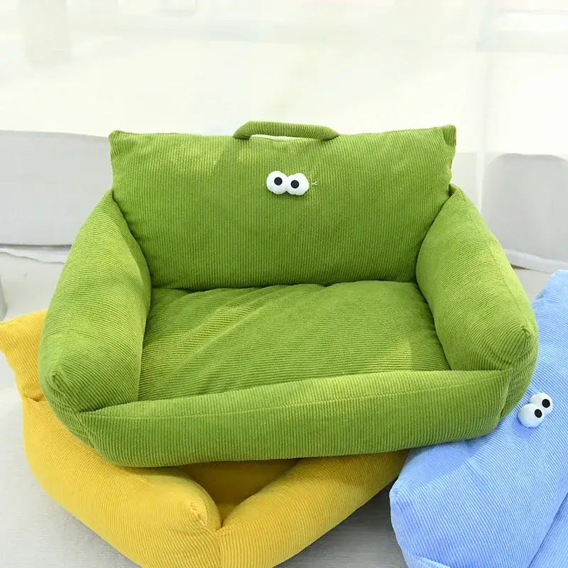 Bright green plush pet bed with cartoon eyes on the backrest.