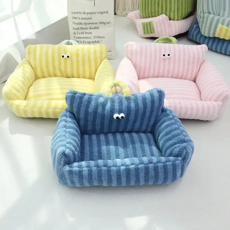 Colorful plush pet beds shaped like miniature sofas with cute cartoon eyes.