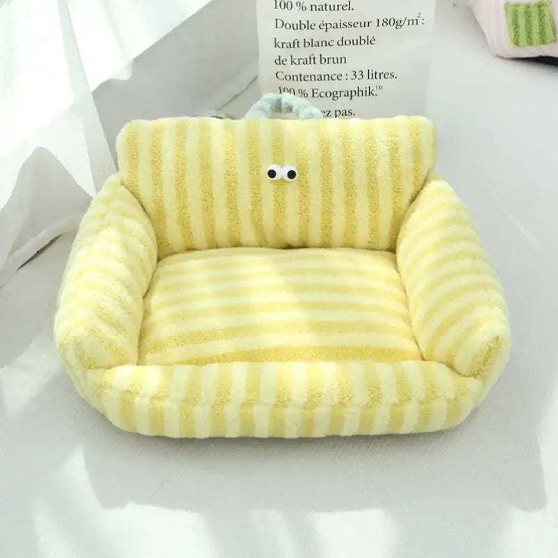 Cute yellow plush armchair with cartoon eyes.