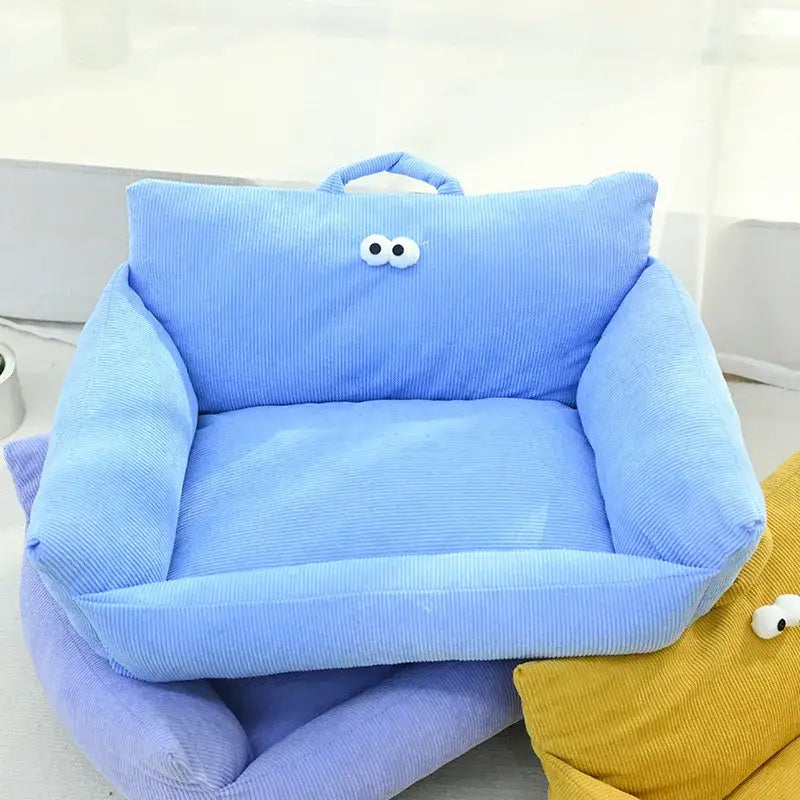 Light blue plush children’s armchair with cartoon eyes on the backrest.