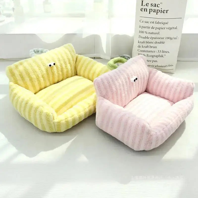 Pair of plush, miniature armchairs in yellow and pink.