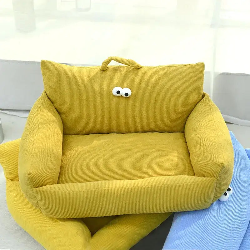 Yellow corduroy armchair with cartoon eyes, designed for children.