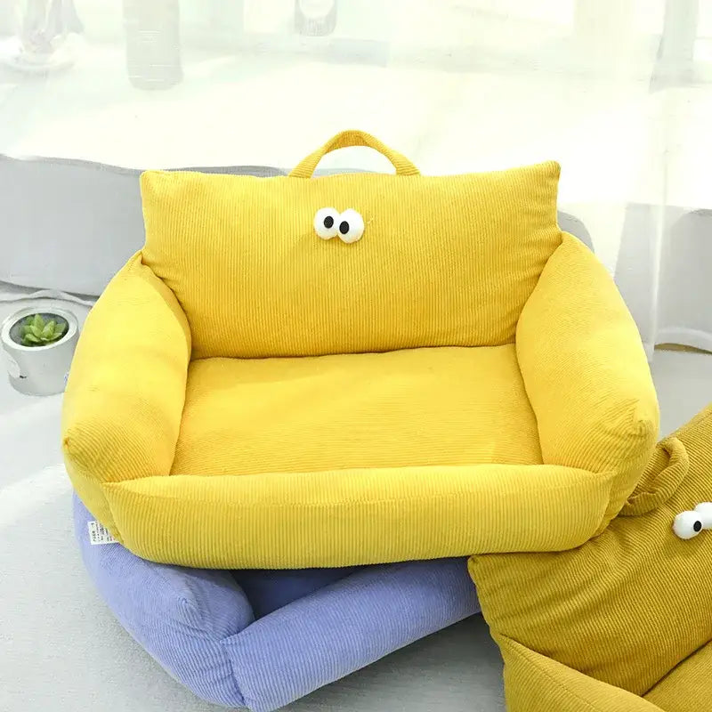 Yellow corduroy children’s armchair with cartoon eyes on the backrest.