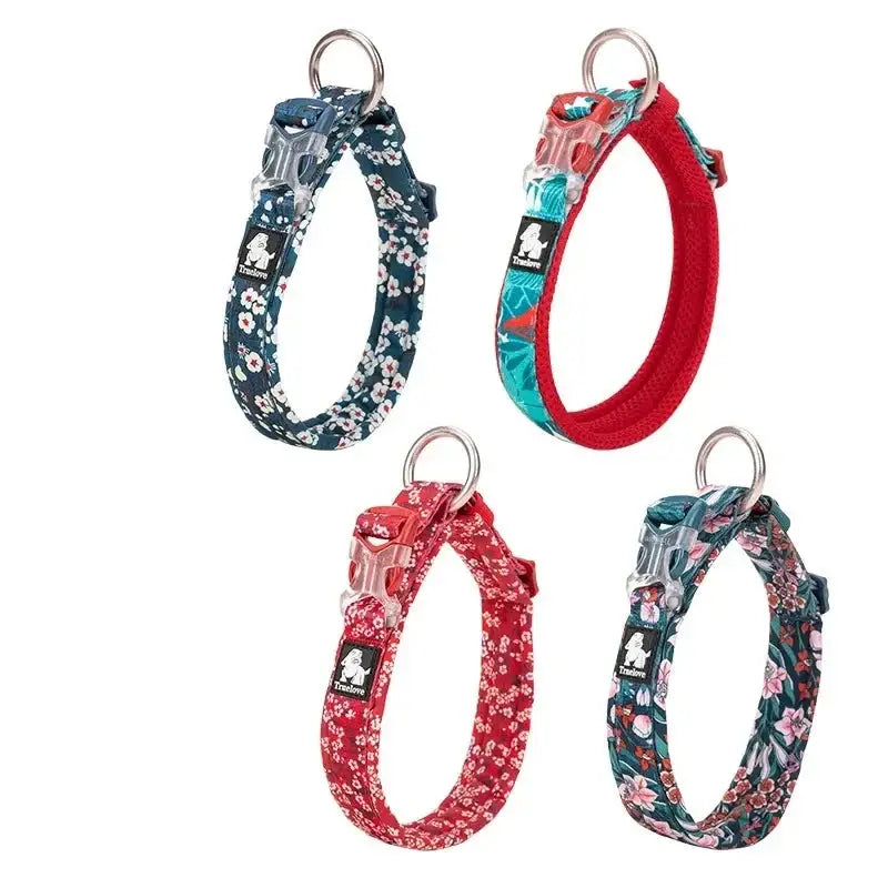 Four colorful patterned dog collars with metal rings attached.