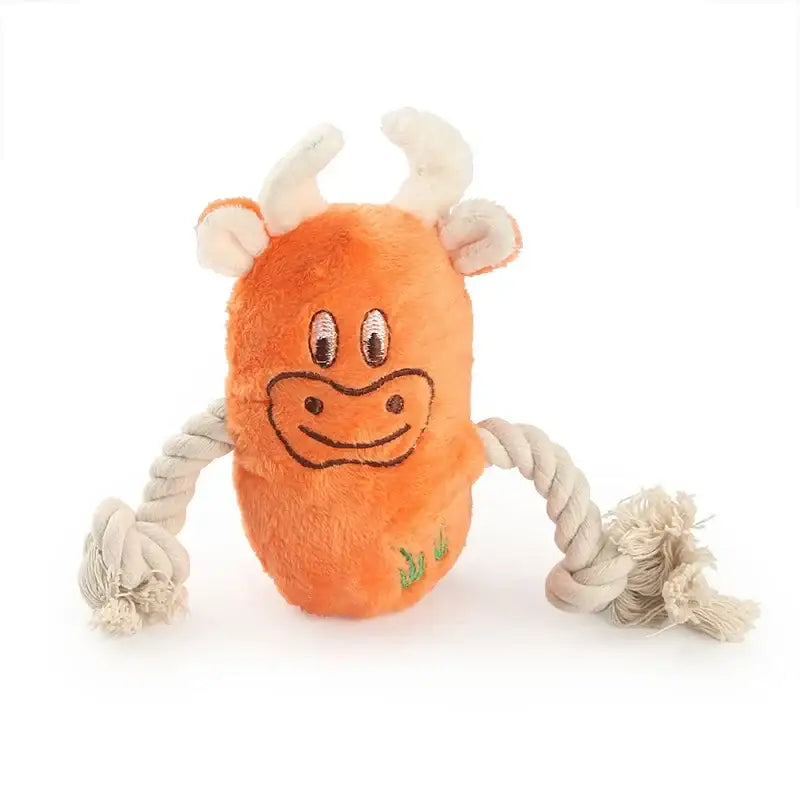 Orange plush cow toy with rope arms and a smiling face.