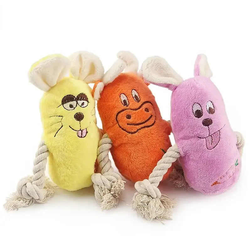 Three colorful plush dog toys with cartoon faces and rope attachments.