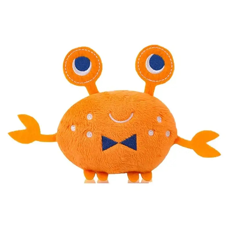 Cute orange plush toy monster with googly eyes and claw-like arms.