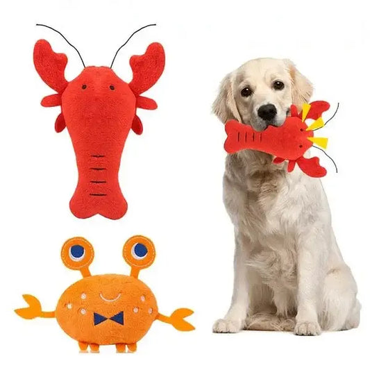 Golden Retriever dog holding a red lobster toy in its mouth.