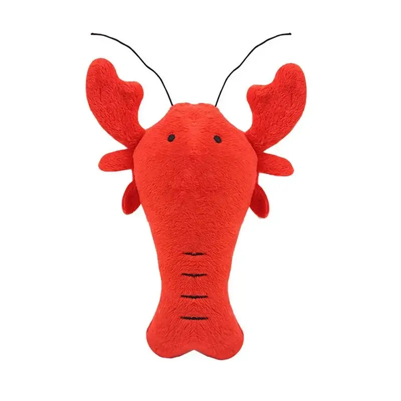 Red plush toy lobster with simple facial features and antennae.