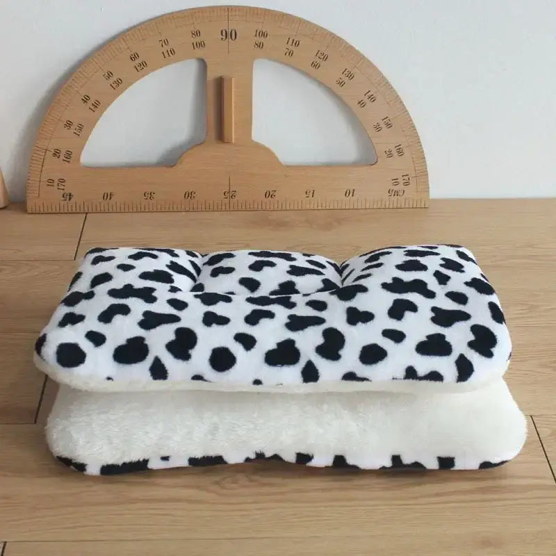 Folded fabric with a black and white spotted pattern resembling dalmatian fur.