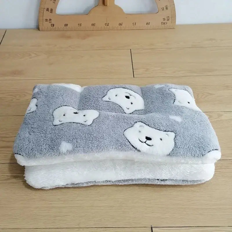 Soft gray blanket or towel with white bear face designs.