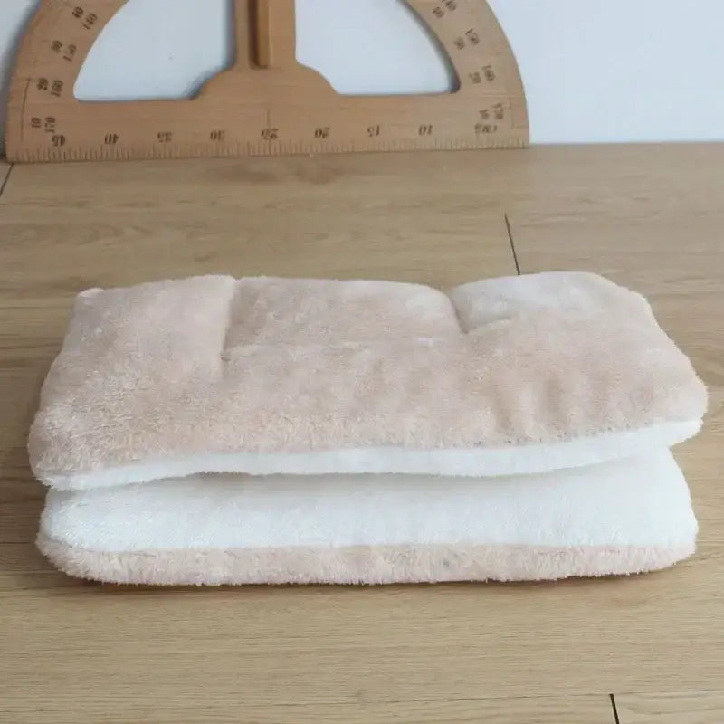 Stack of folded towels or washcloths on a wooden surface.