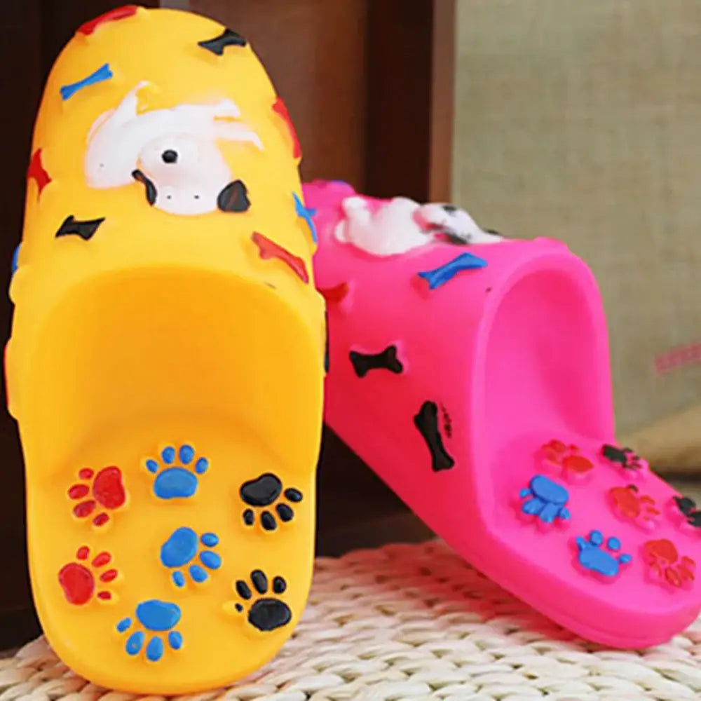 Colorful dog-shaped plastic containers decorated with paw prints and bone shapes.