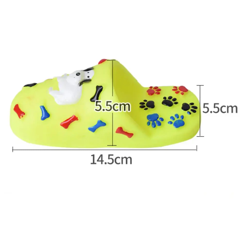 Lime green dog-themed slipper or clog with colorful paw prints and bone designs.