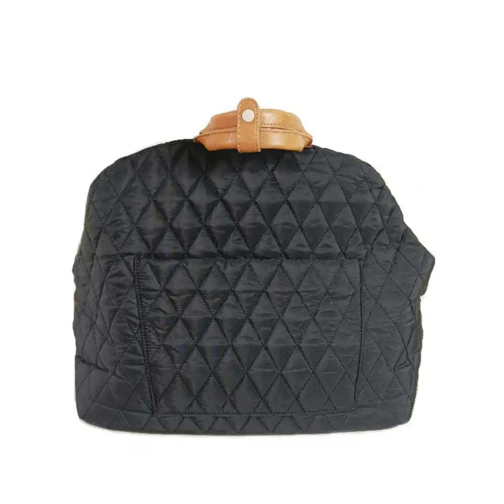 Quilted black handbag with a tan leather clasp on top.