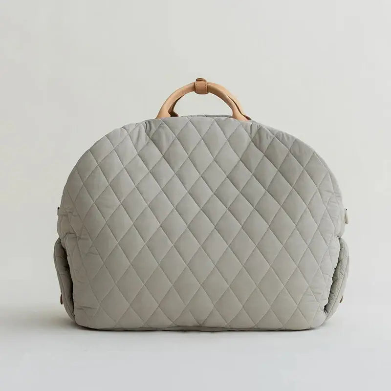 Quilted gray handbag with wooden handle.