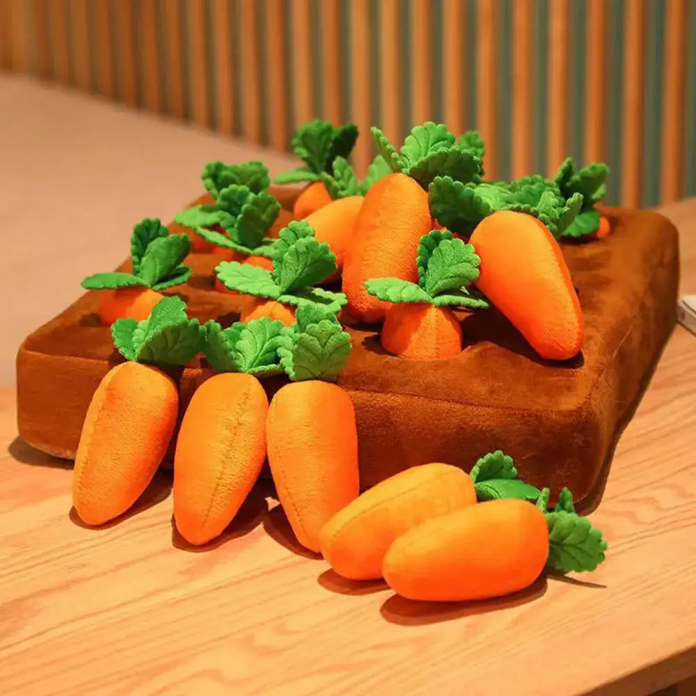 Wooden tray filled with bright orange carrots and green leafy tops.