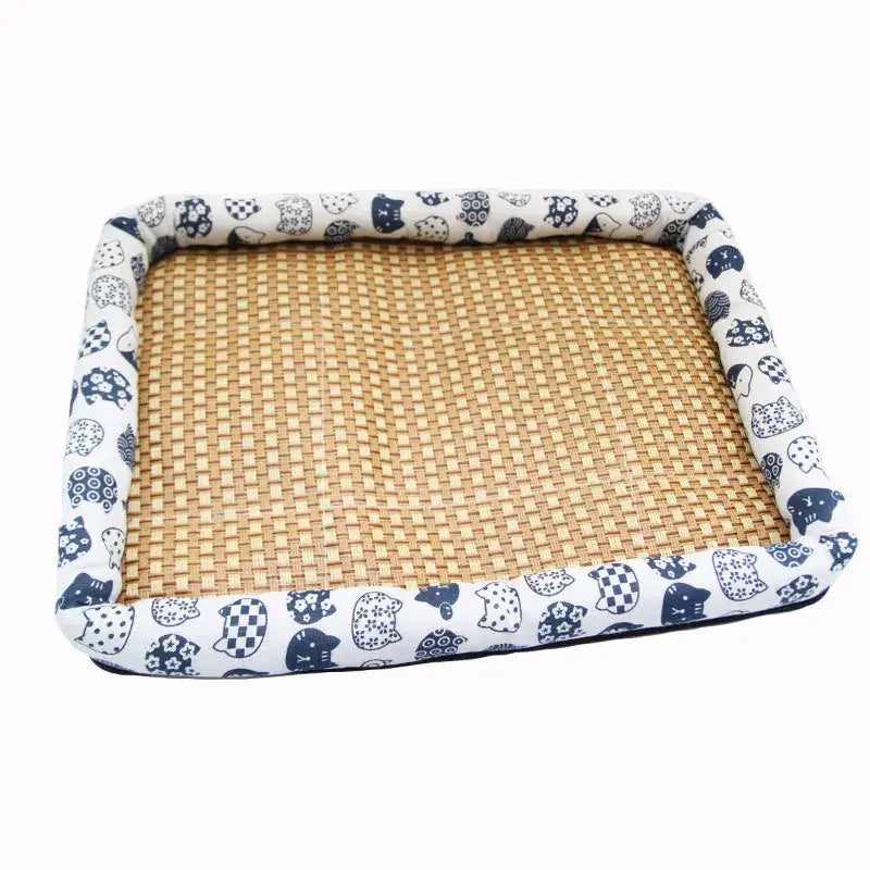 Pet bed with a woven rattan base and patterned fabric border featuring owl designs.