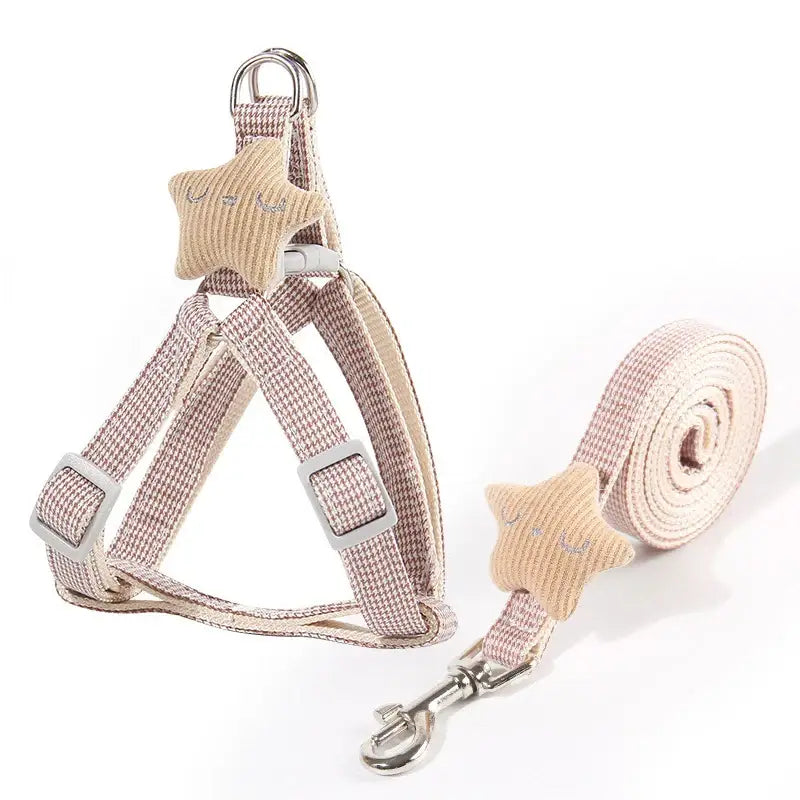 Dog harness and leash set in light beige color with fabric star accents.