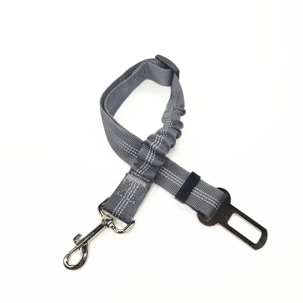 Dog seatbelt safety harness with adjustable strap and metal clip.