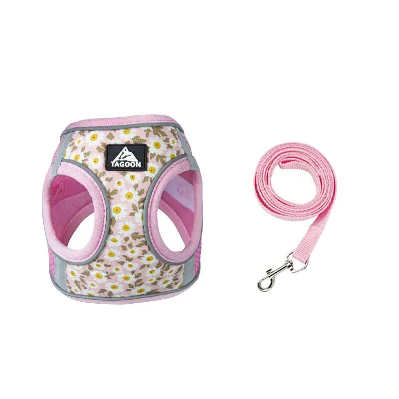 Floral-patterned dog harness with pink trim and a matching pink leash.