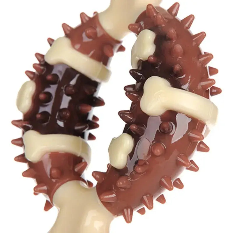 Gummy candy shaped like a spiky sea creature, likely an octopus tentacle, with alternating brown and white segments.